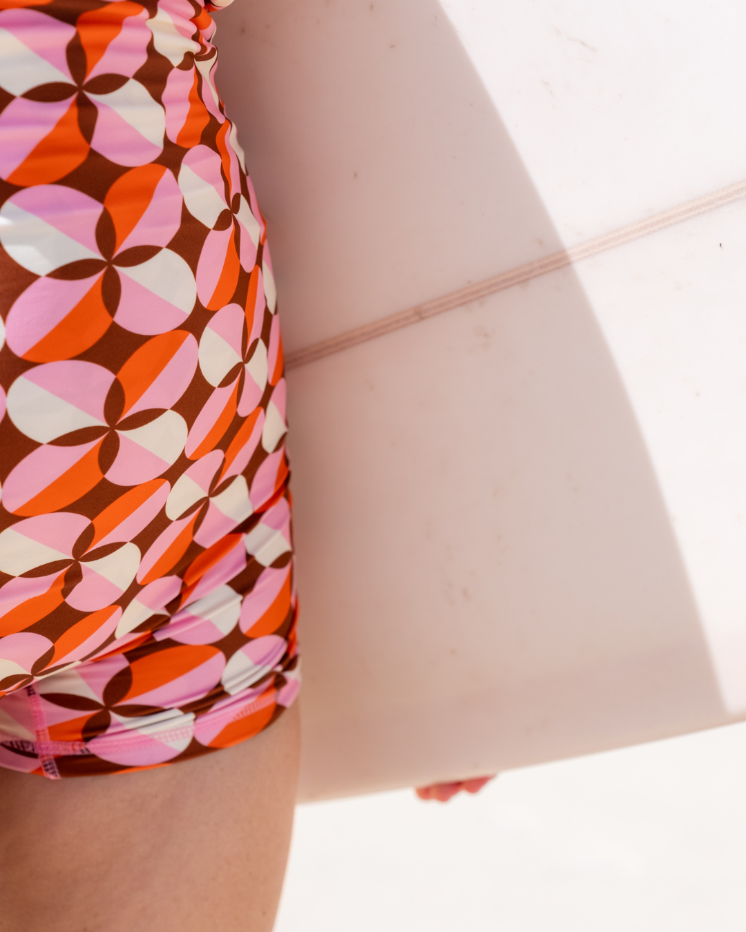 Women's swimming onesie and swim bodysuit in Sunburst print, by Sunfolk Swimwear Australia